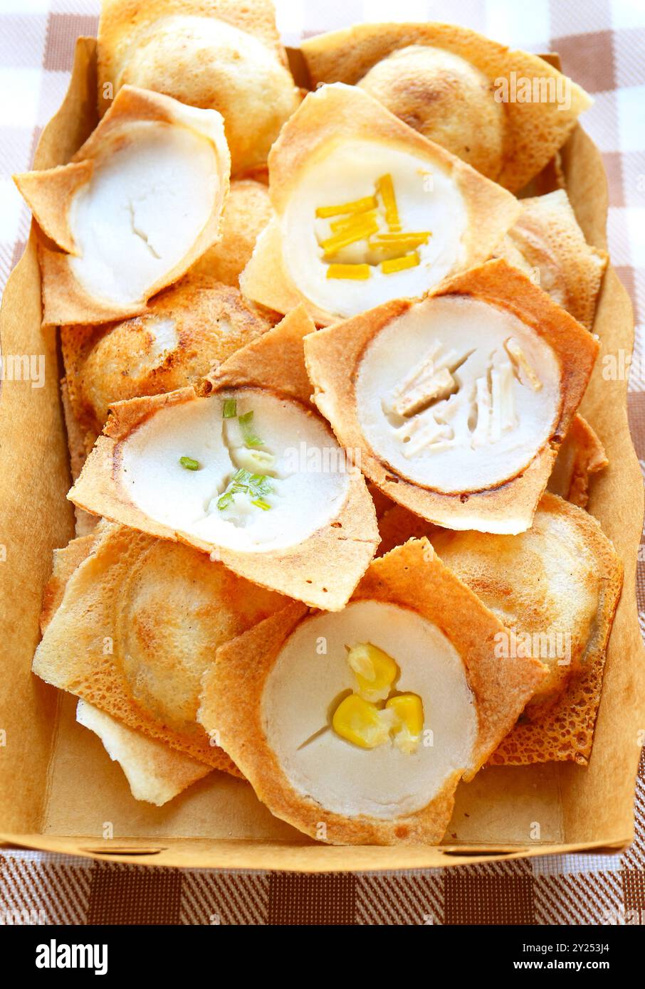Sweet and fragrant Thai coconut milk pancakes called Kanom Krok with Assorted Topping of Fruits and vegetables Stock Photo