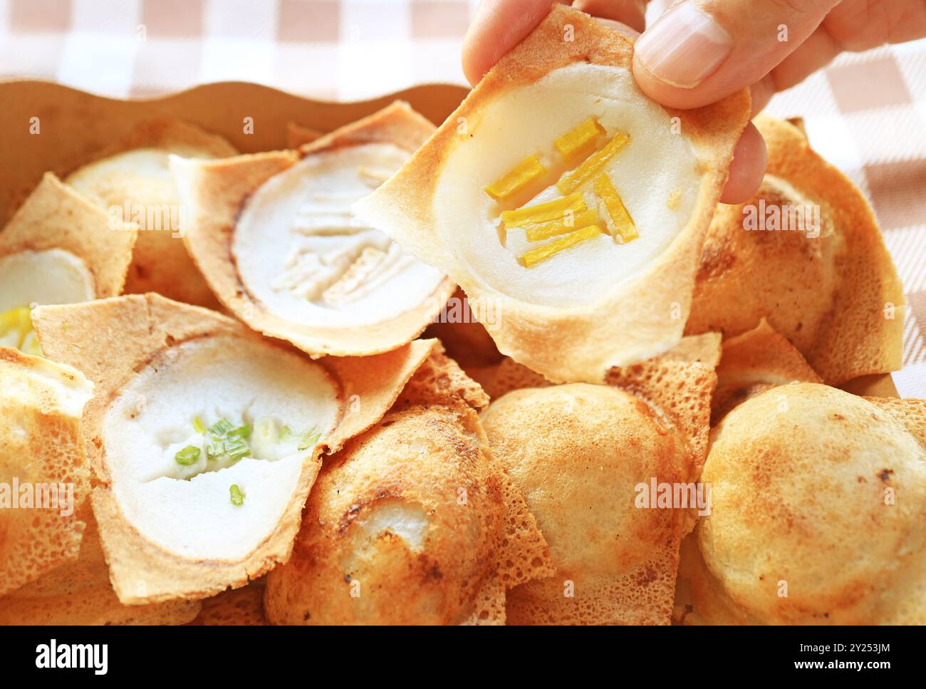 Hand  Picking Pumpkin Topping Kanom Krok, Thai coconut milk pancake which one of the popular street food in Thailand Stock Photo