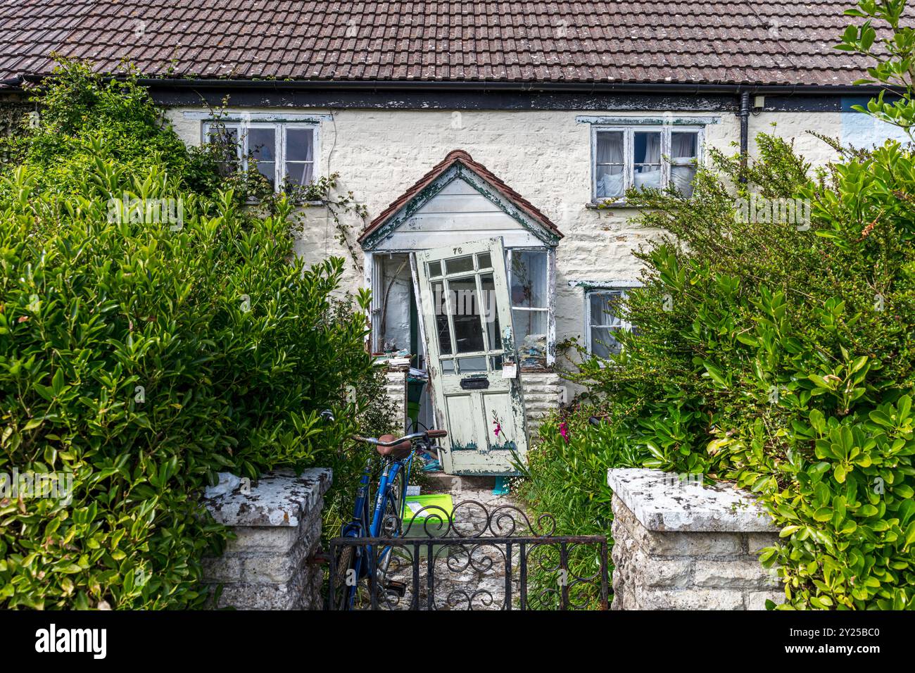 Upwey, Dorset, UK, England, Upwey village, broken door, front door, broken, door, derelict, derelict house, rough, rough area, rough house, unkempt, Stock Photo