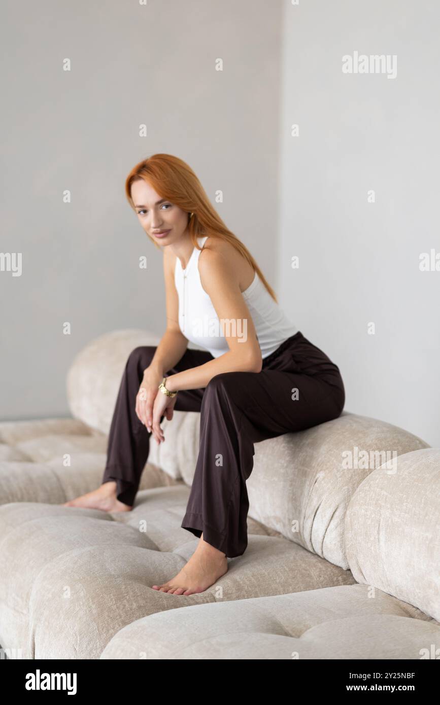 Calm serene young woman relaxing on comfortable couch at home with ...