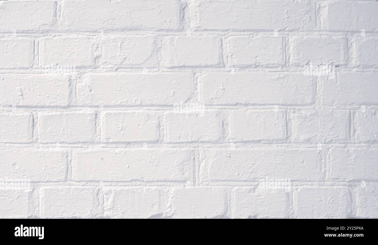 White painted brick wall with smooth texture, suitable for backgrounds or design elements in various settings Stock Photo
