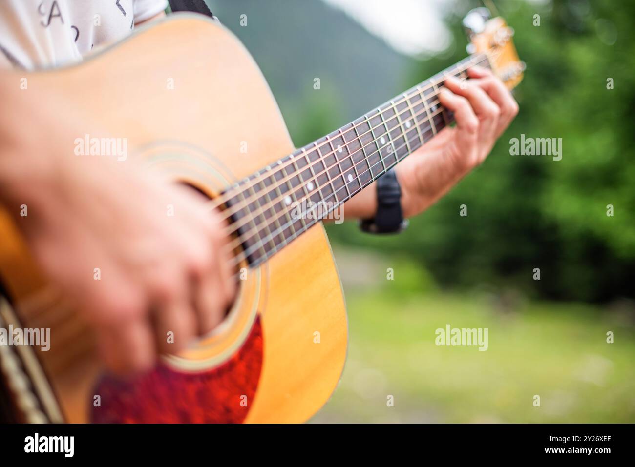 A young man plays the guitar. Stock Photo