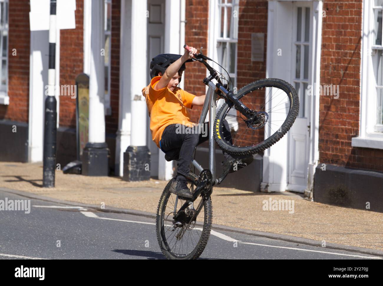 Kid doing wheelie on bike hotsell
