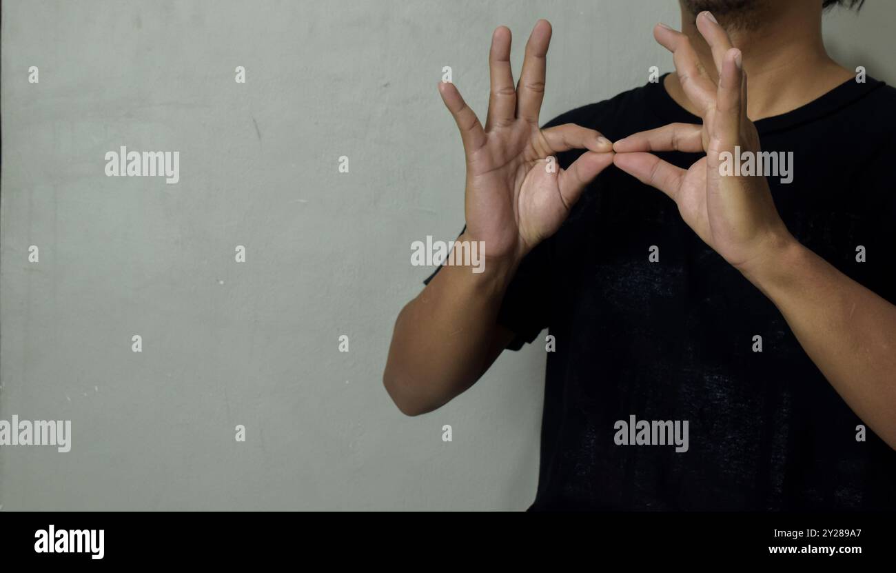 young man using sign language interpreter to communicate Stock Photo