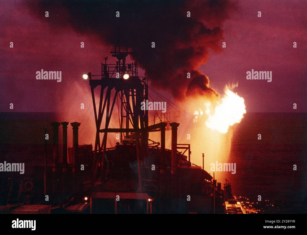 Burning off petroleum gas on a drill ship during oil exploration in the Gulf Of Thailand in the 1980's. Stock Photo
