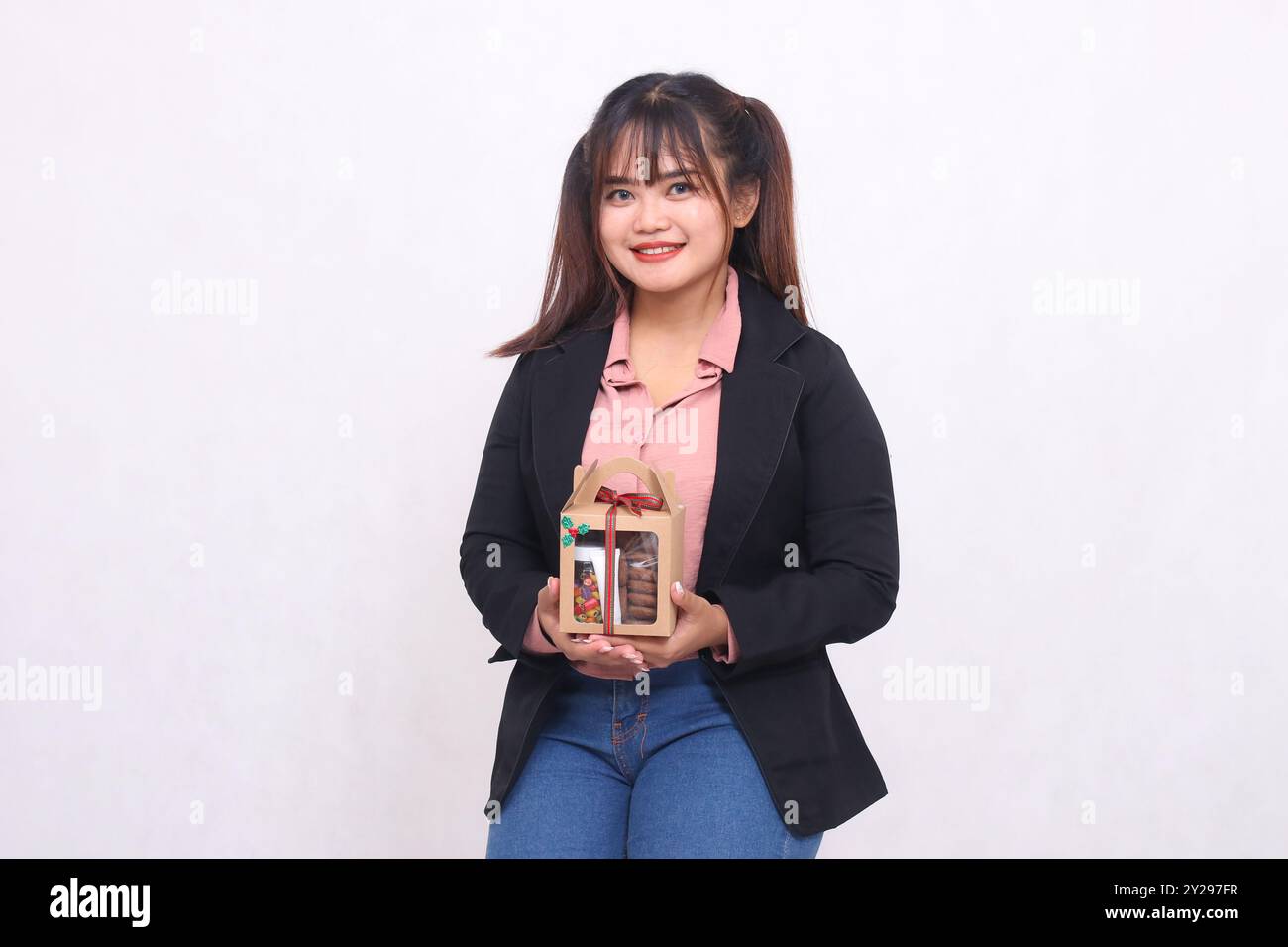 Beautiful Asian girl smiling excitedly while posing with Christmas ...