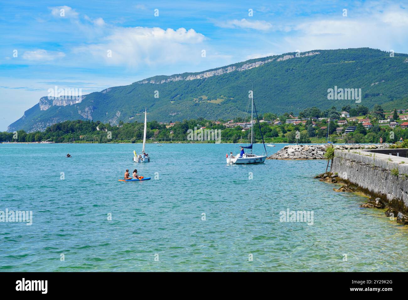 AIX-LES-BAINS, FRANCE -5 JUL 2024 – Day view of boats on Lac du Bourget lake in Savoie, Alps, France, in Aix-Les-Bains, a resort spa town on famous fo Stock Photo