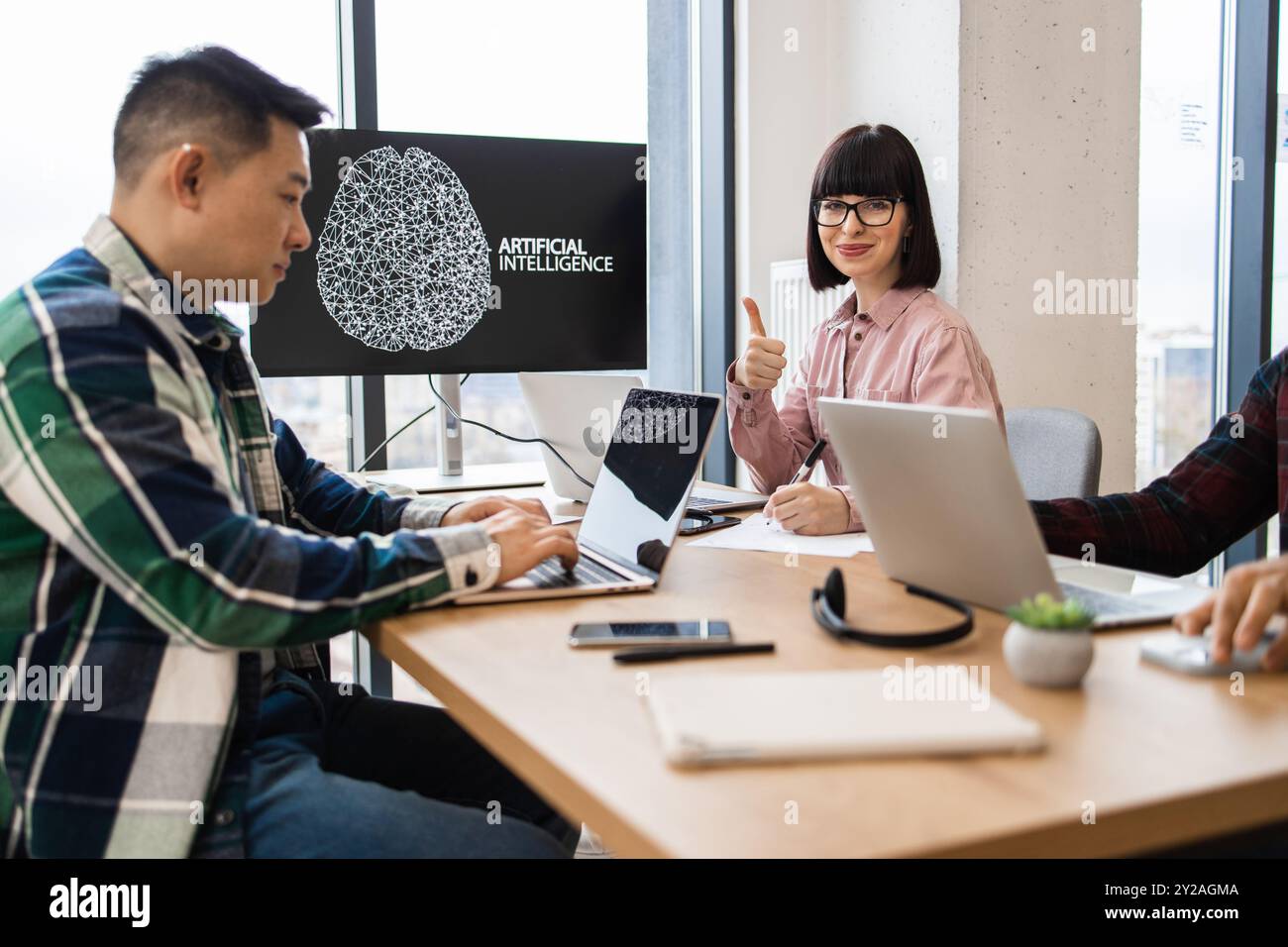 IT experts collaborating on artificial intelligence development Stock Photo