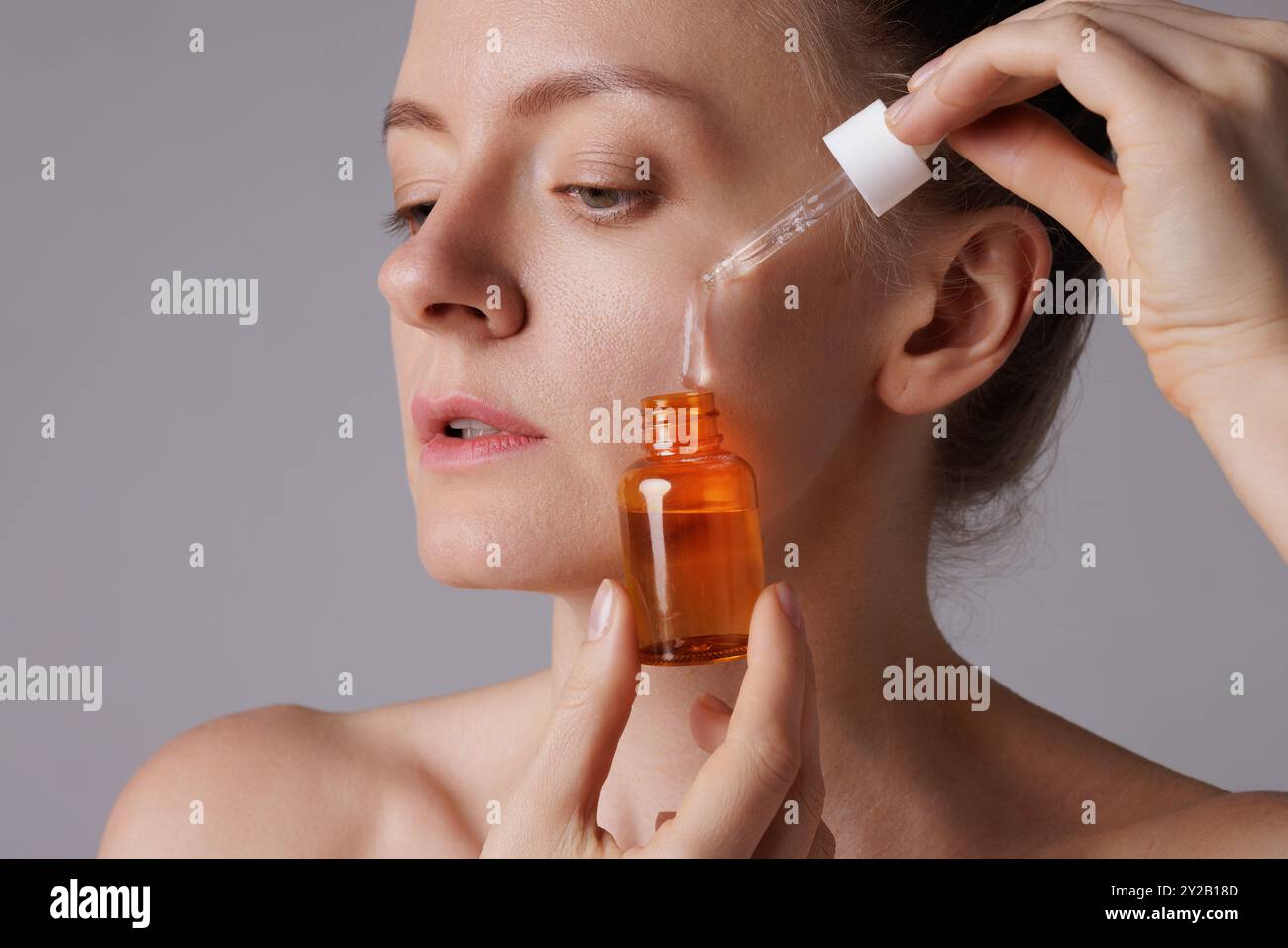 Woman applying retinol serum drop hi-res stock photography and images ...