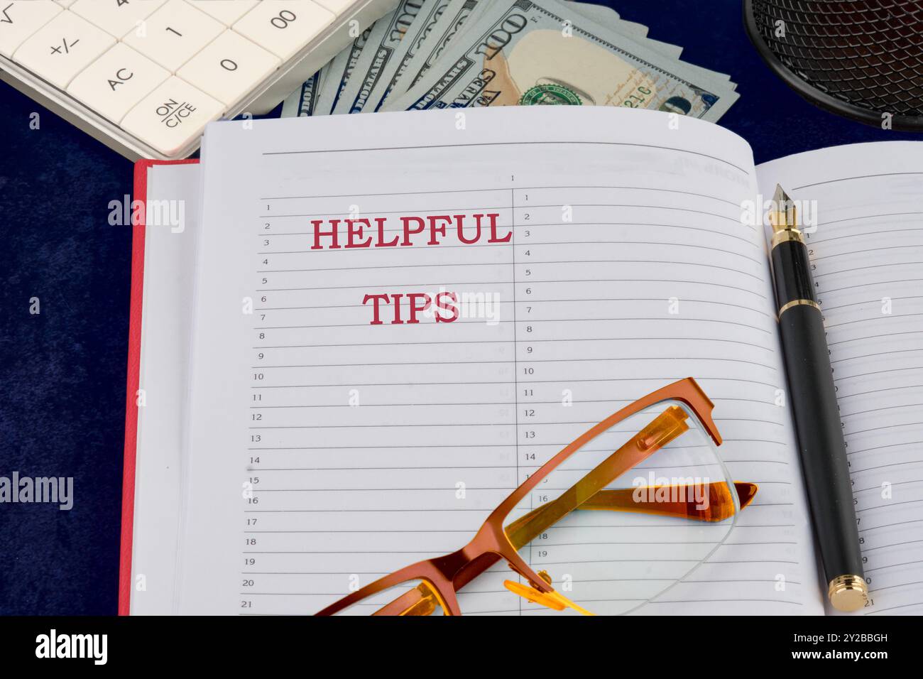 Helpful Tips words writing in a notebook on a dark background Stock Photo