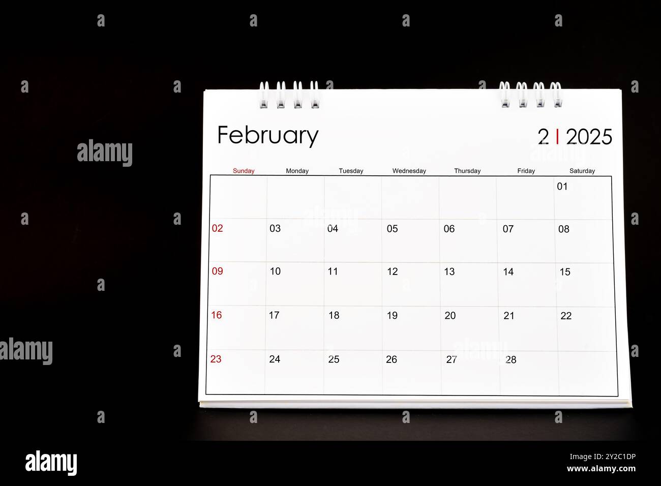 Desk calendar for february 2025. desktop calendar on a black color  background stock photo - alamy