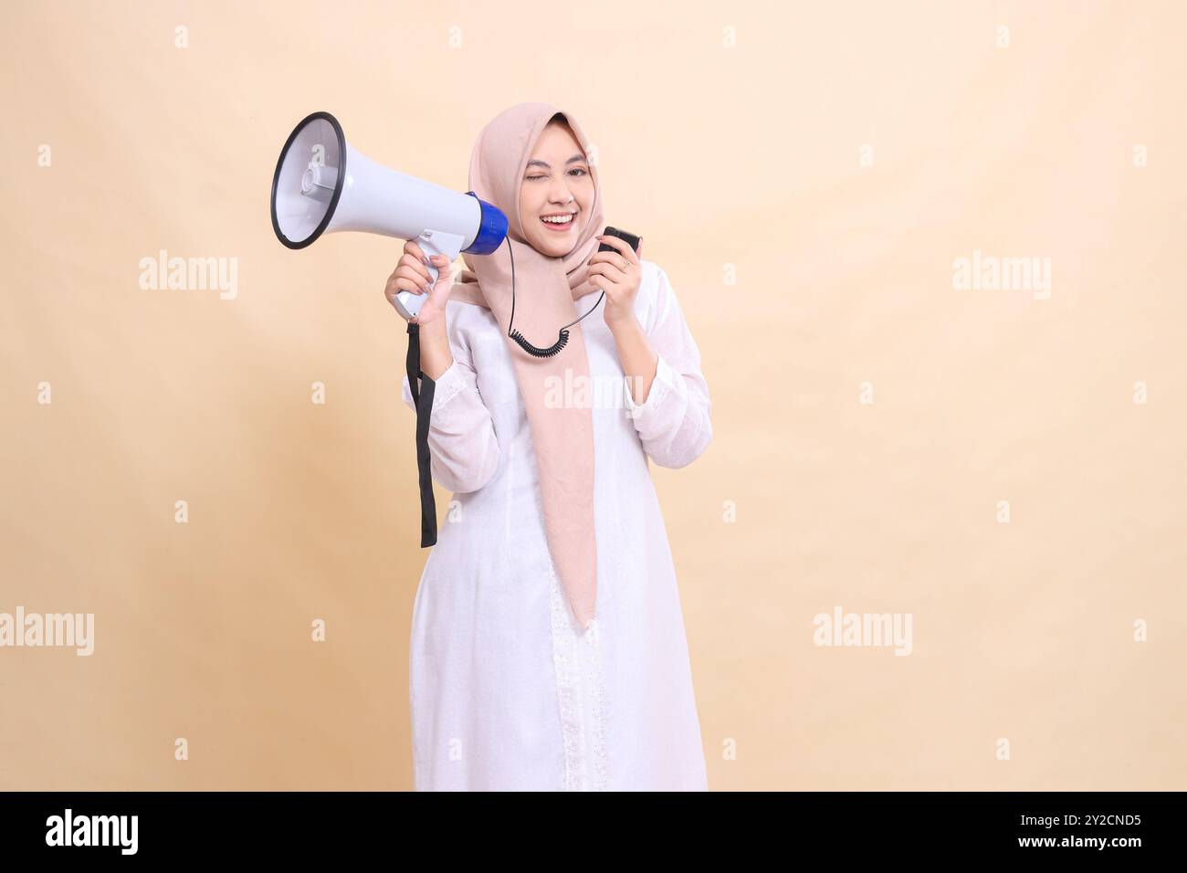 girl indonesia muslim wearing a hijab at the camera shouts, smiles ...