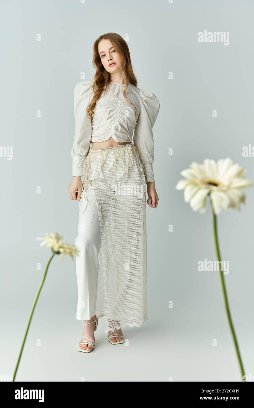 A beautiful young woman poses elegantly with fresh blooms around her ...