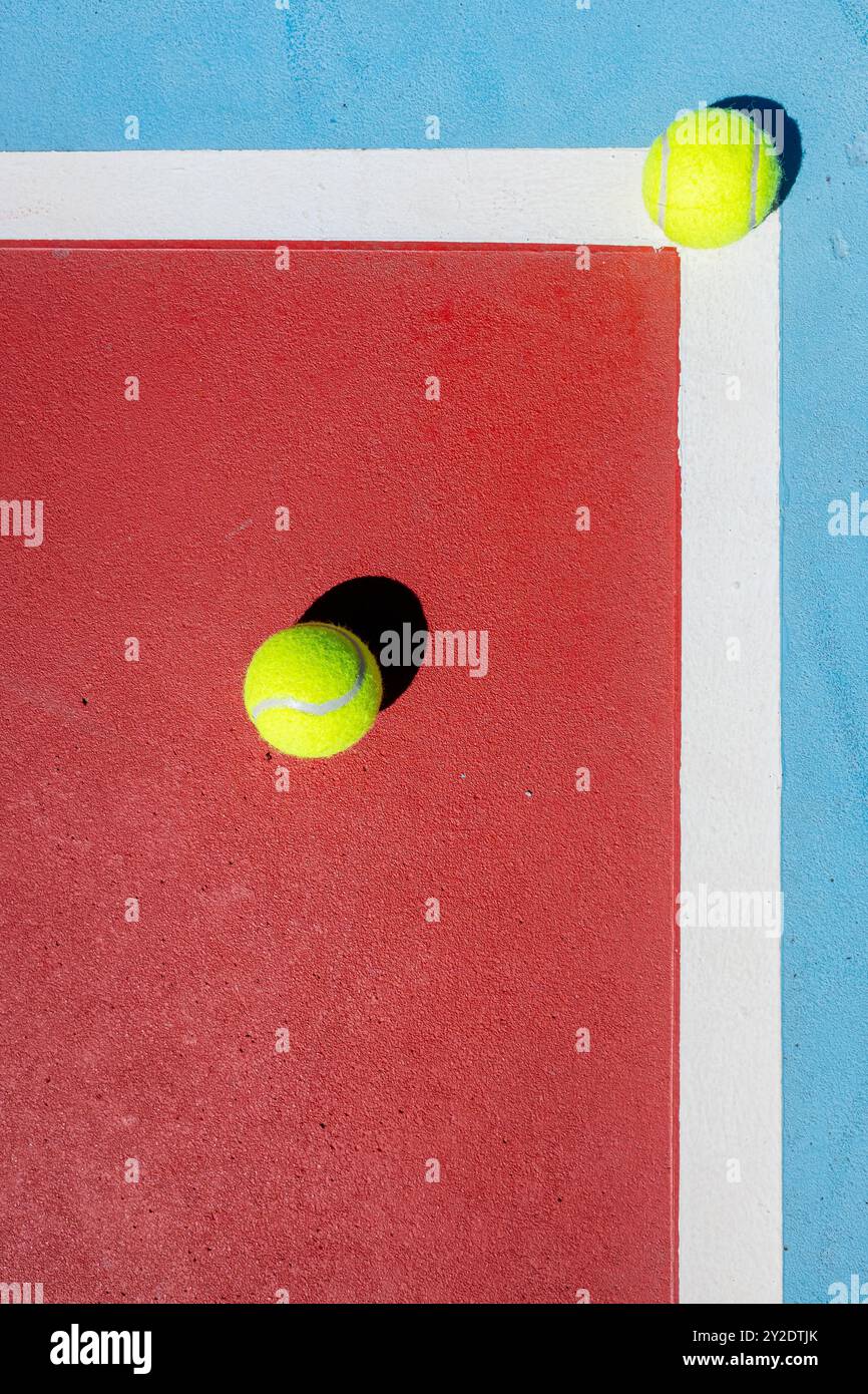 zenithal view of two tennis balls on a red and blue tennis court Stock ...