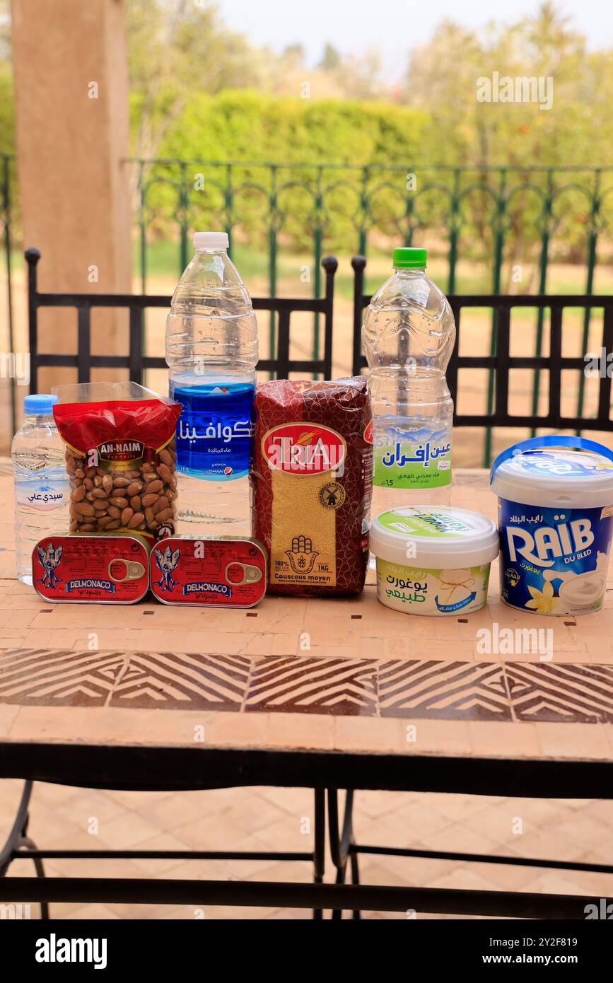 Moroccan food products purchased at the supermarket: Mineral water, sardines, semolina, almonds, yogurt, fromage blanc. Marrakech, Marrakech-Safi Regi Stock Photo