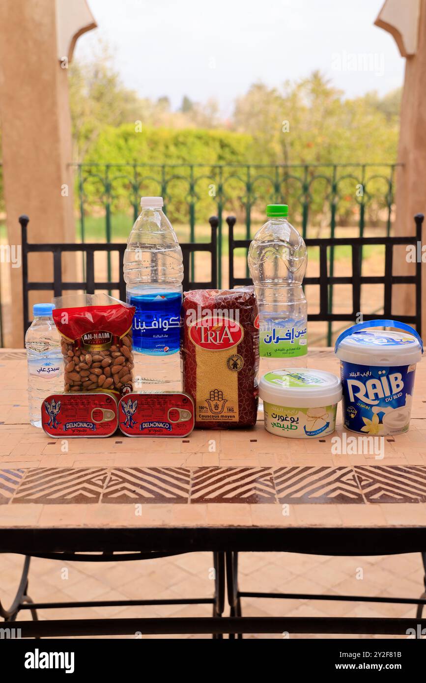 Moroccan food products purchased at the supermarket: Mineral water, sardines, semolina, almonds, yogurt, fromage blanc. Marrakech, Marrakech-Safi Regi Stock Photo