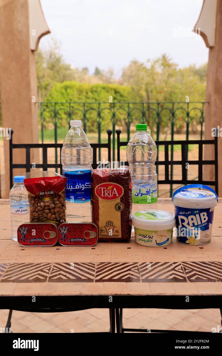 Moroccan food products purchased at the supermarket: Mineral water, sardines, semolina, almonds, yogurt, fromage blanc. Marrakech, Marrakech-Safi Regi Stock Photo