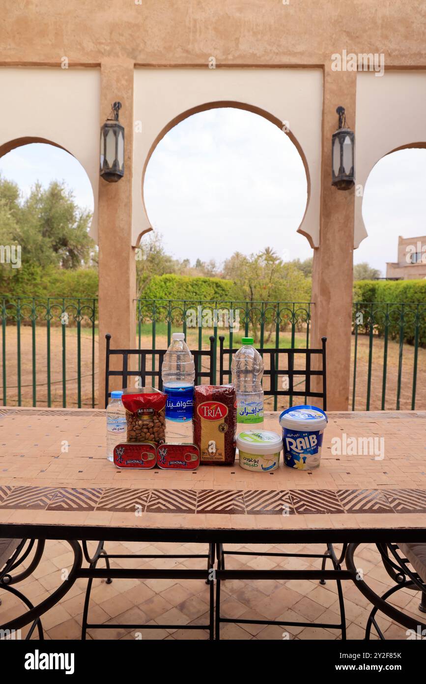 Moroccan food products purchased at the supermarket: Mineral water, sardines, semolina, almonds, yogurt, fromage blanc. Marrakech, Marrakech-Safi Regi Stock Photo