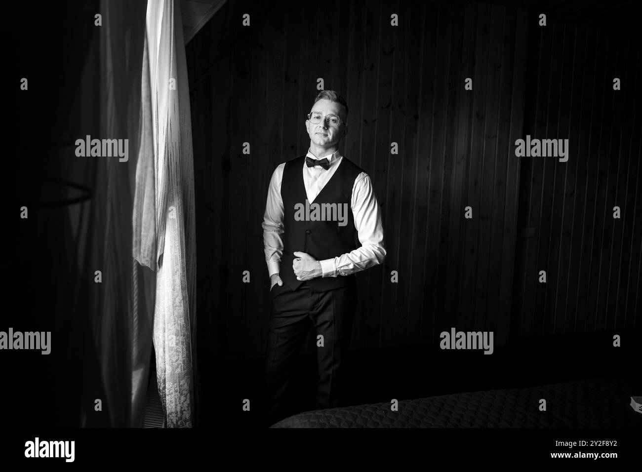 Elegant Portrait of a Man in Formal Attire with Dramatic Lighting in a ...