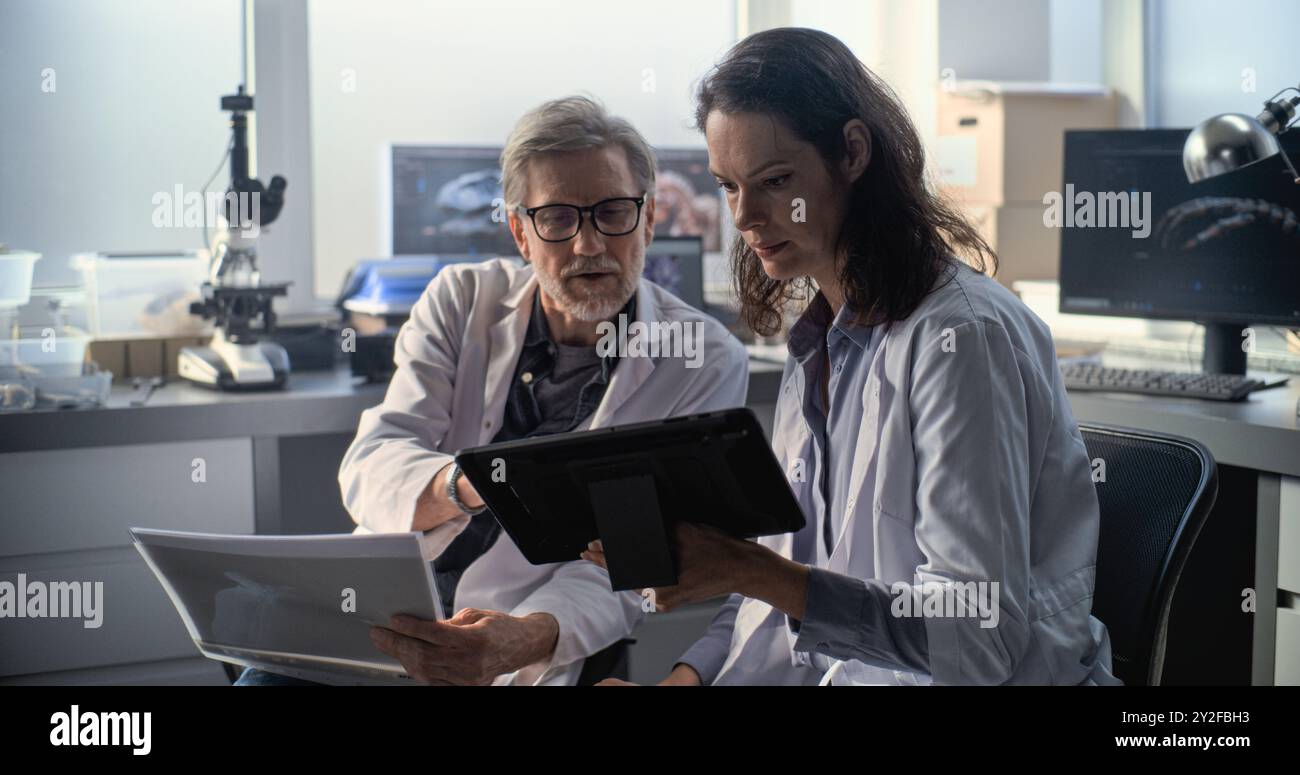 Male and female scientists in lab coats conduct scientific research ...