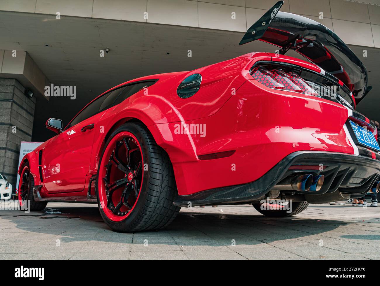 Suzhou, China - March 30, 2019: Teal mustang at a car show with custom exhaust and spoiler Stock Photo