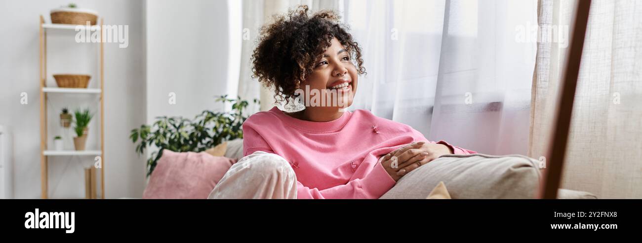 A joyful young woman relaxes in her cozy living room Stock Photo - Alamy