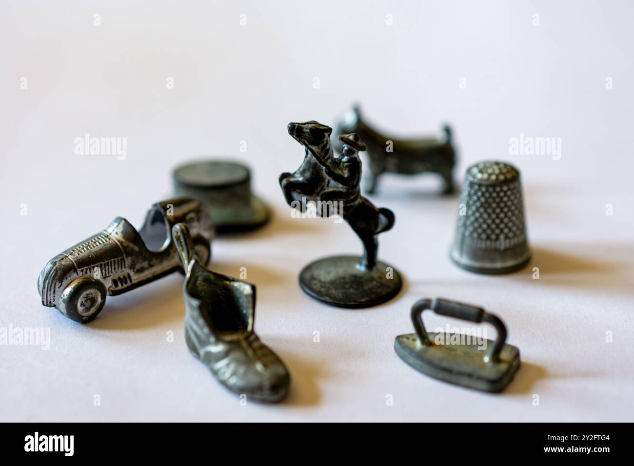 Original Monopoly markers including horse, iron, shoe, car, hat, dog, and thimble on white background. Stock Photo