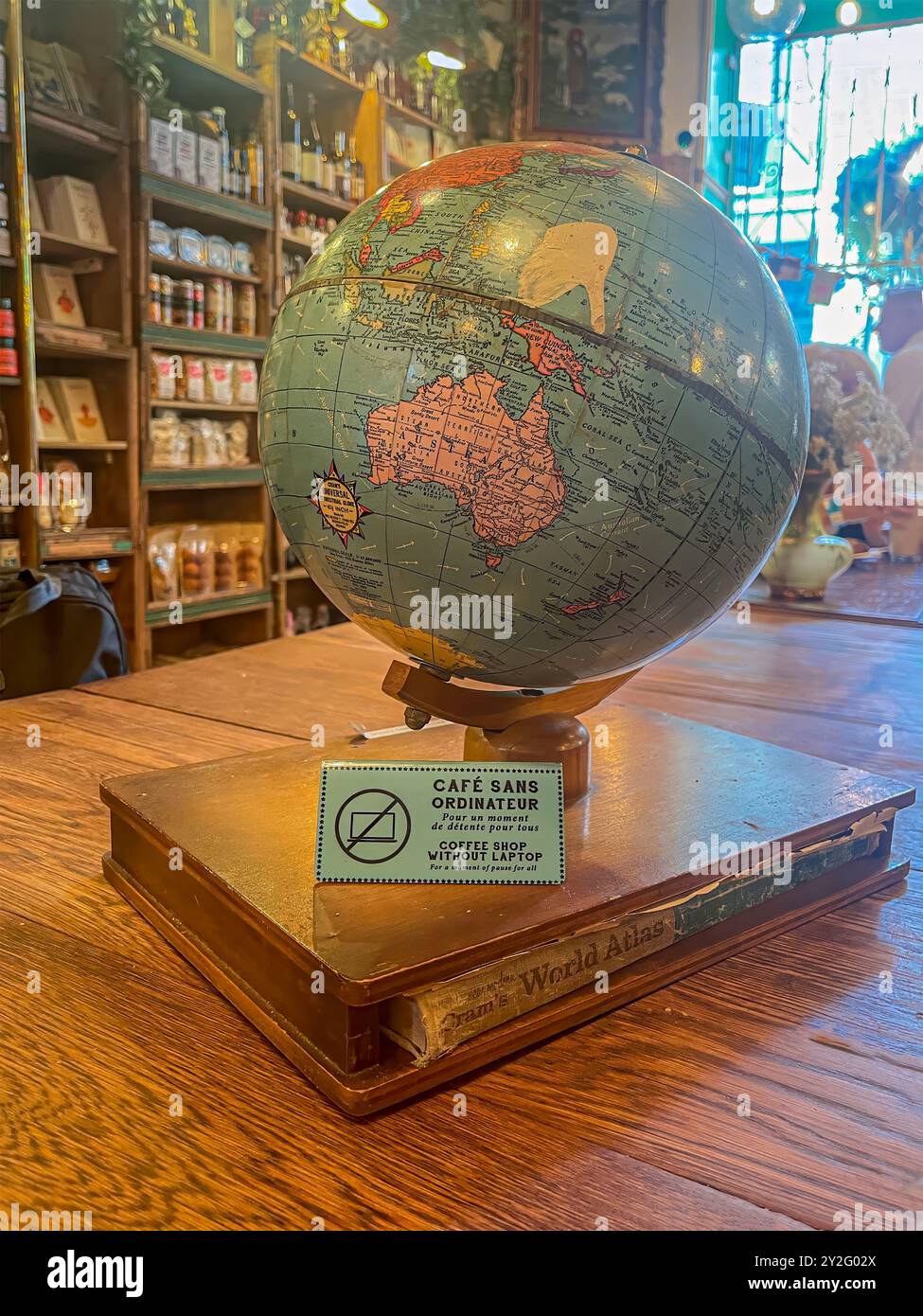 Montreal, Quebec, Canada - June 20, 2024: inside Le Petit Dep coffee shop, at 185 St Paul Street W, without laptop. Globe on table, grocery stores she Stock Photo