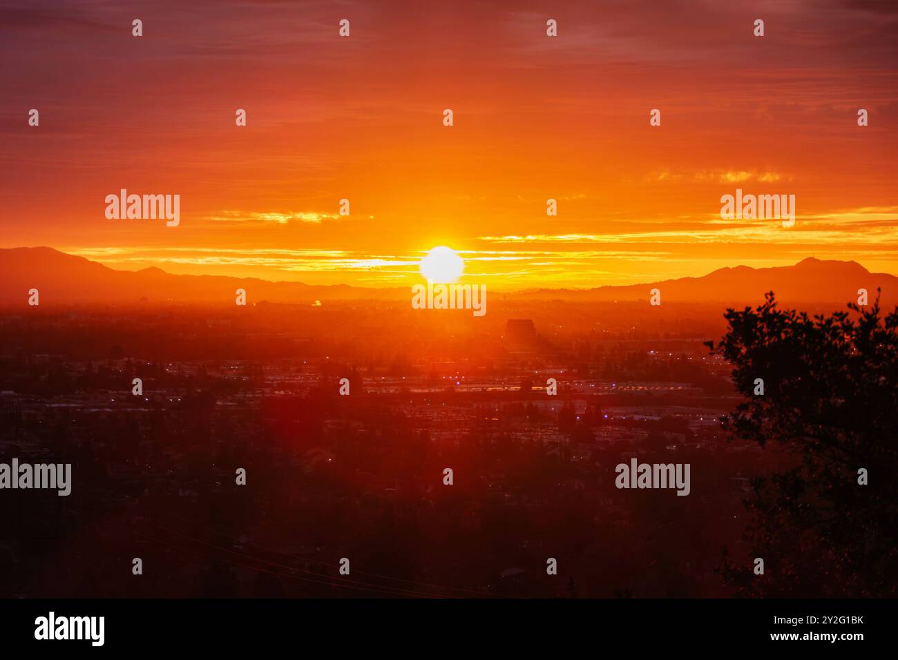 Los Angeles dawn sunshine bursting through layers of fog above the San ...