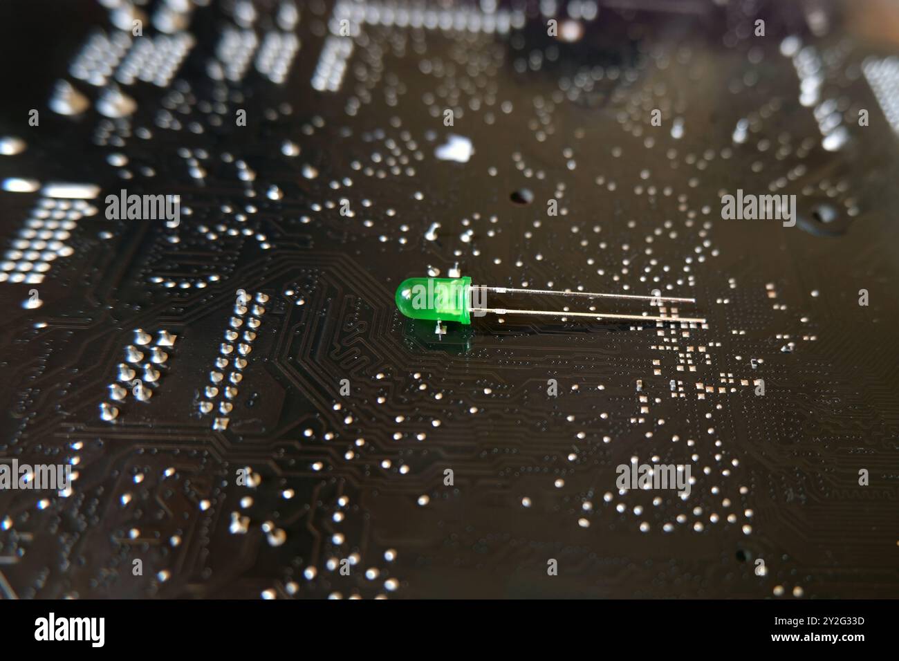 Green LED or Light Emitting Diode standing on the high technology patterned floor. Stock Photo