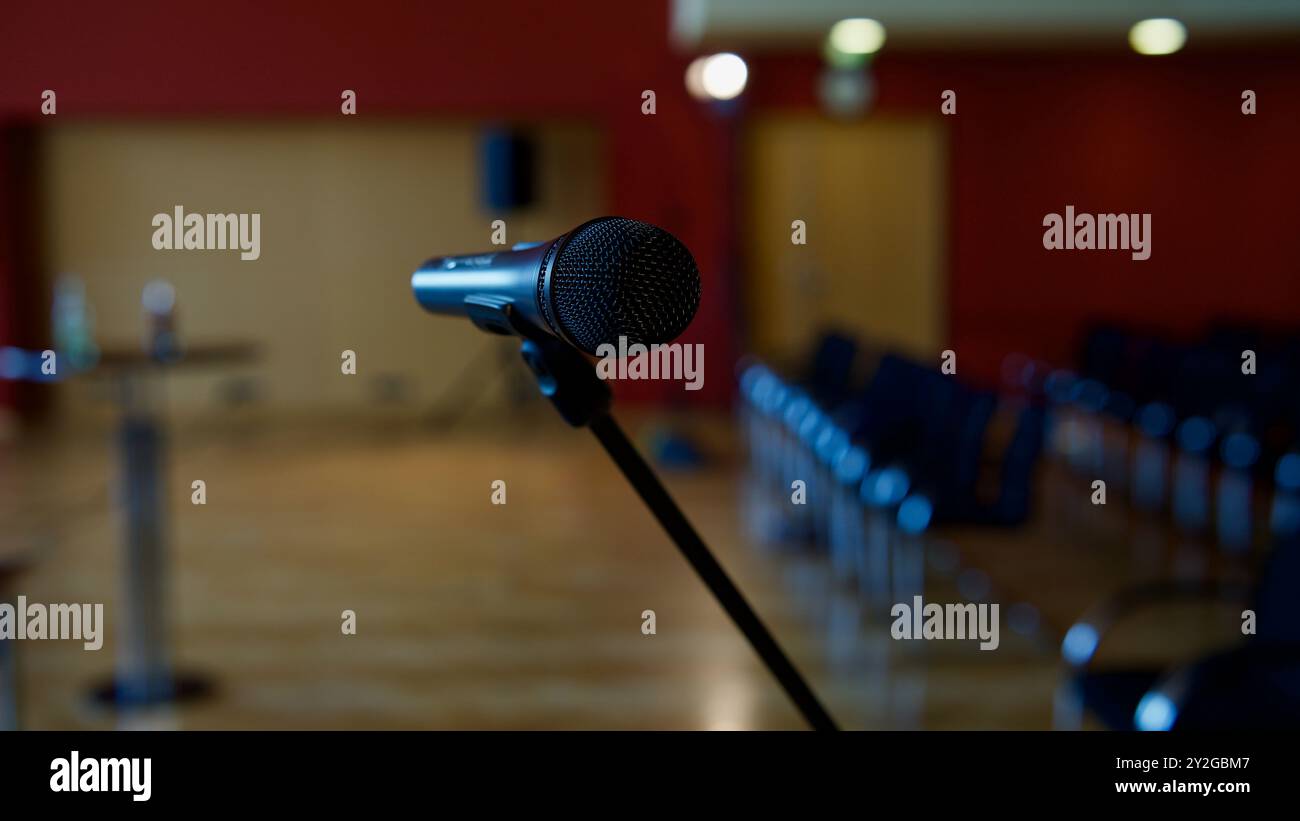 A microphone in an empty concert hall. Rows of chairs Stock Photo - Alamy