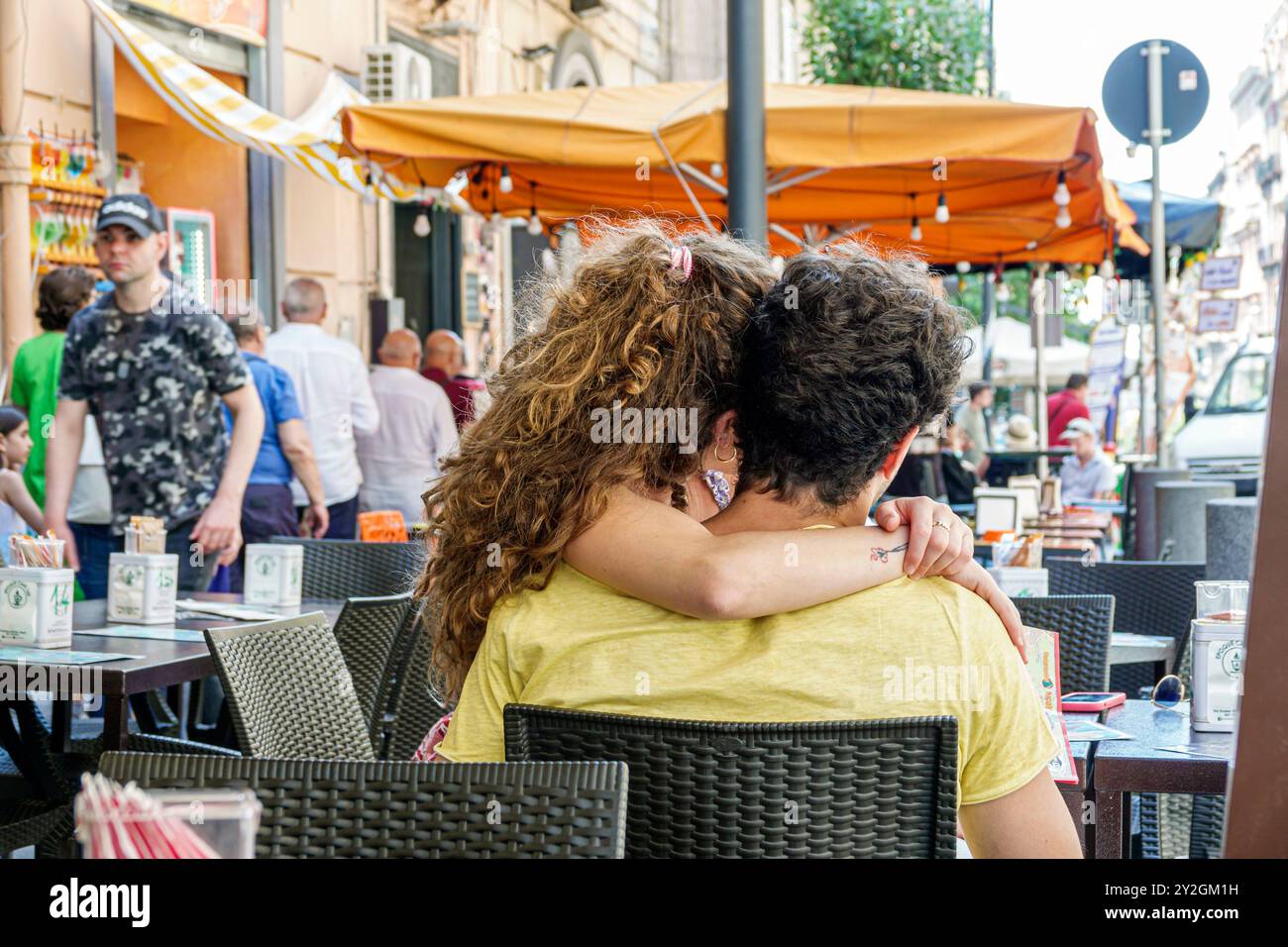 Naples Napoli Italy,Via Duomo,Caffe Duomo del professore,cafe restaurant,romantic couple,male female,young adults,al fresco dining,sitting in lap kiss Stock Photo
