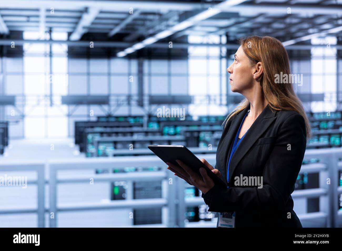 Computer scientist doing disaster recovery planning and security protocol enforcement in data center. IT staff member in server room working to reduce downtime, ensuring business continuity Stock Photo