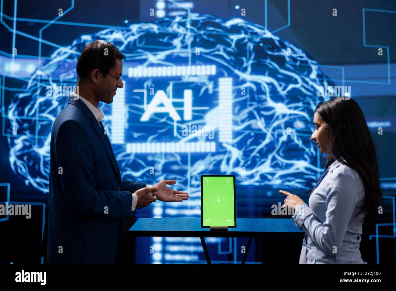 Engineer and supervisor use AI machine learning to extract information from complex data on isolated screen tablet. Experts in workspace use artificial intelligence technology on chroma key device Stock Photo