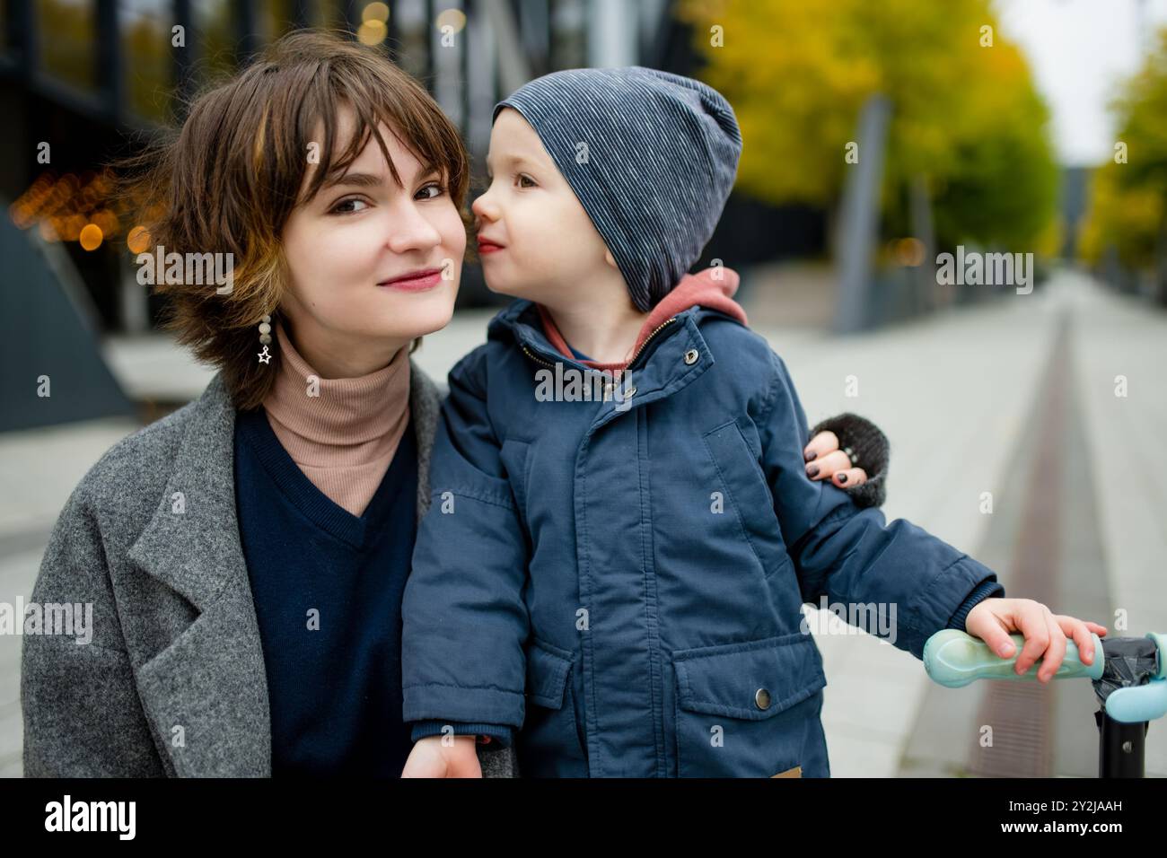 Teenage sister and her little brother having fun outdoors. Young girls with a toddler boy on autumn day. Children with large age gap. Stock Photo