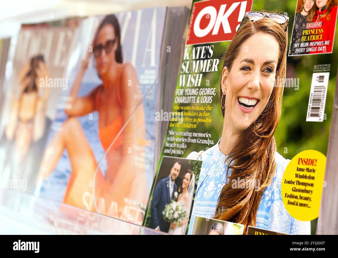 Print media magazine newsstand with press publications including OK! mag featuring gossip, stars, royalty - Princess of Wales Kate Middleton on cover. Stock Photo