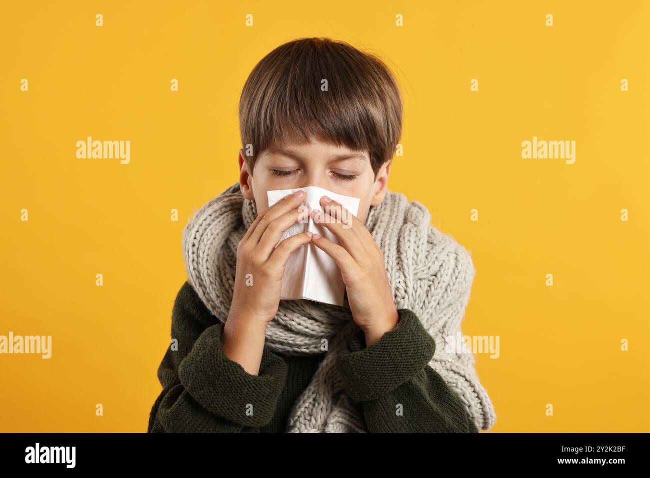 Cold symptom. Little boy with runny nose on orange background Stock ...