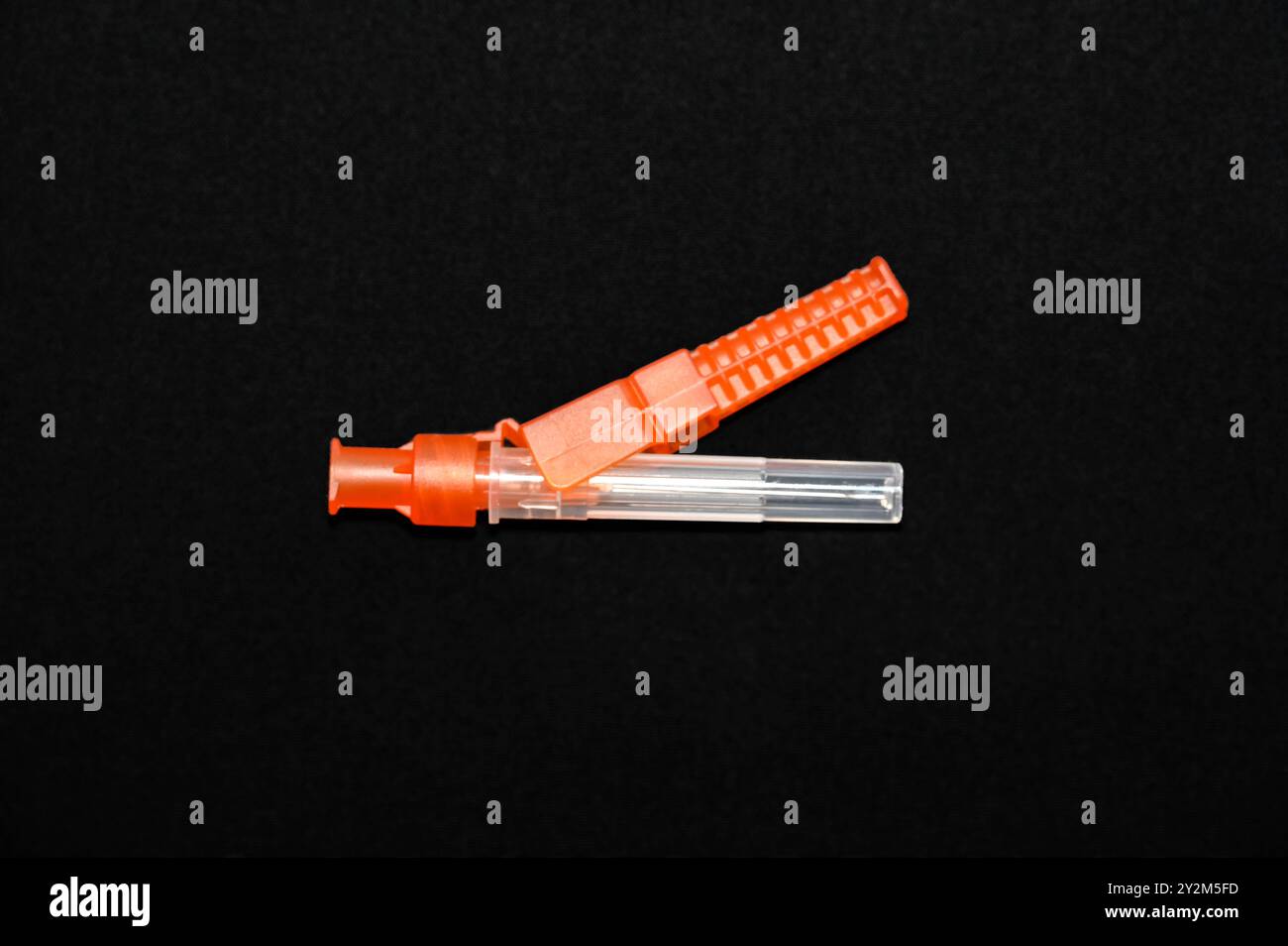 Hypodermic needle in its protective sheath. Stock Photo