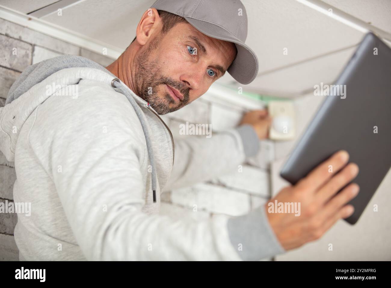 pensive young worker using pc tablet computer while working indoors Stock Photo
