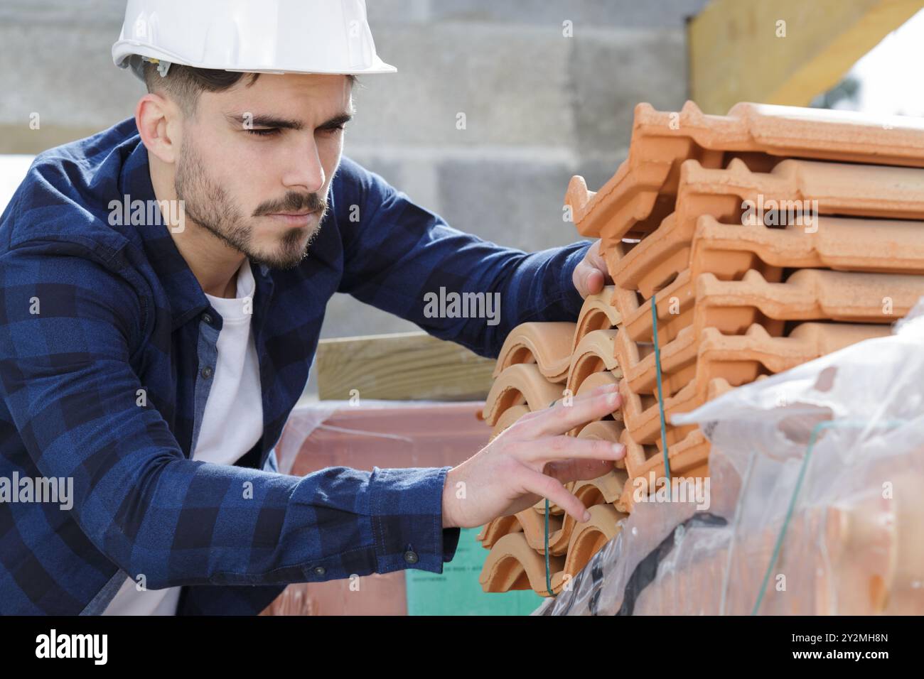 man in builder choosing tiles Stock Photo