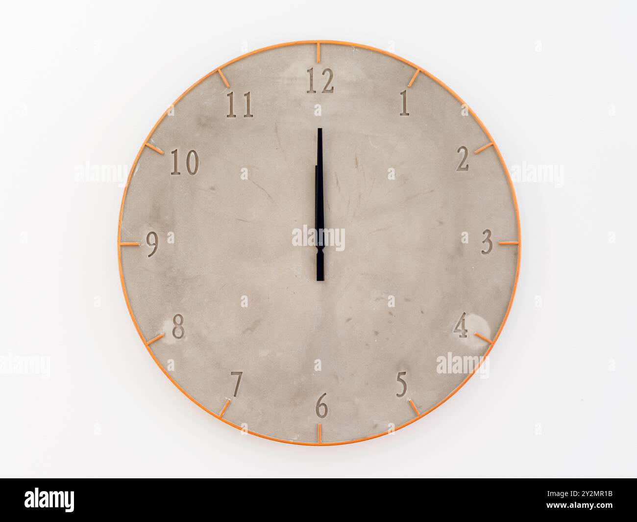 Concrete textured clock on a white background wall. Twelve o`clock ...