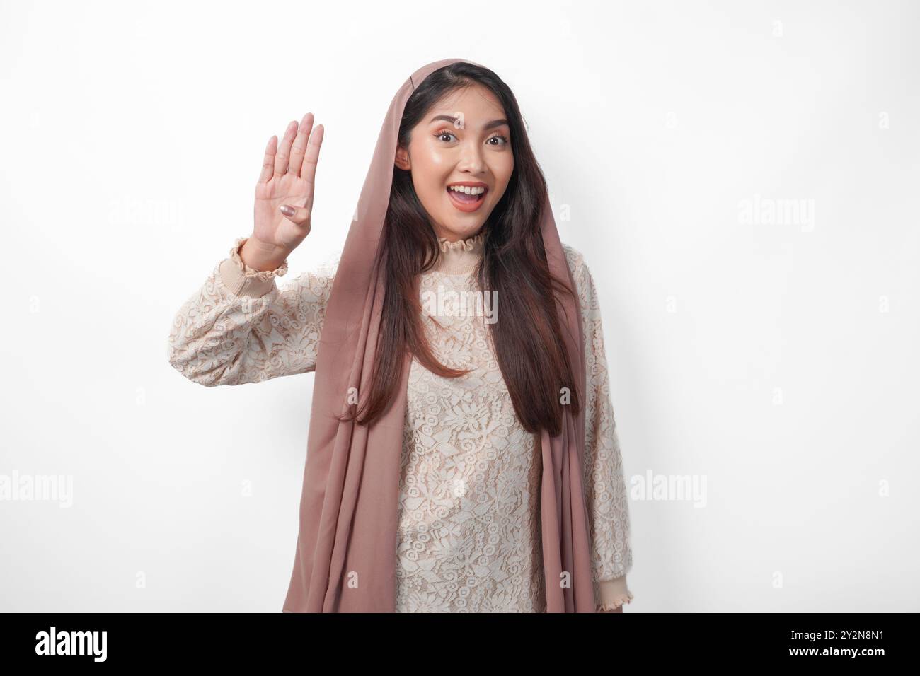 Portrait of attractive Asian Muslim woman wearing veil hijab giving ...