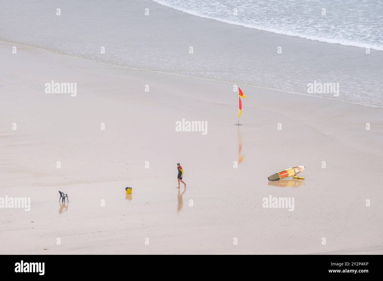 A RNLI Lifeguard on duty on Gt Great Western Beach in Newquay in Cornwall in the UK. Stock Photo