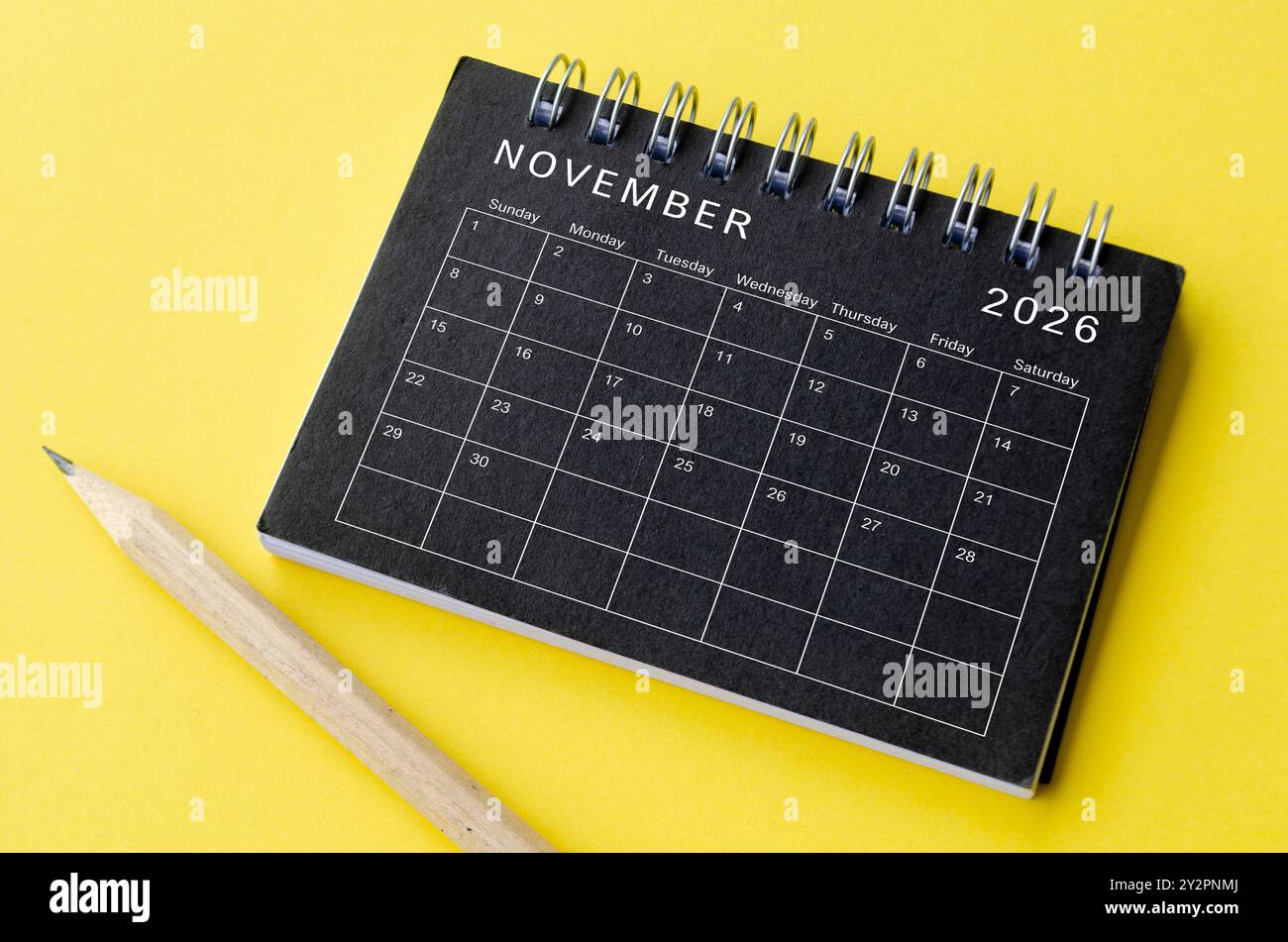 Top view of November 2026 calendar on black notepad with yellow