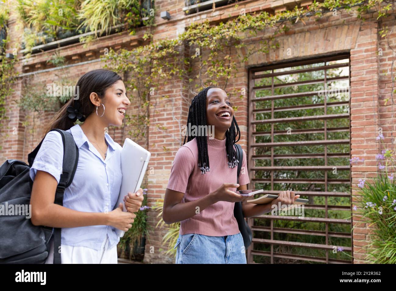 Cheerful students carrying books hi-res stock photography and images ...