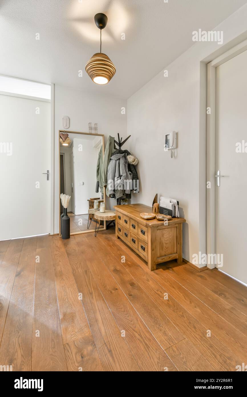 A welcoming home entrance showcasing a wooden console table, mirror ...