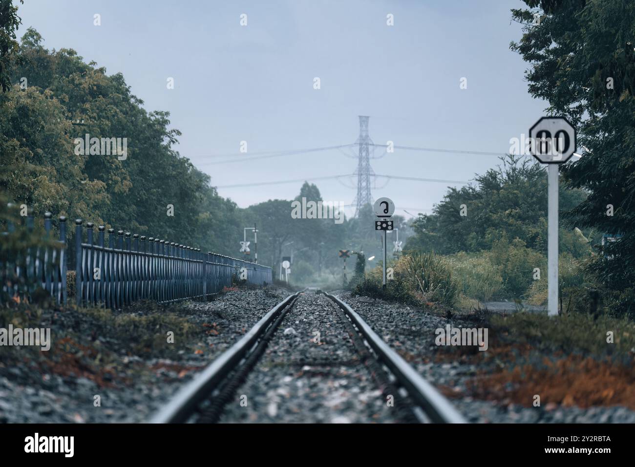 Empty train track, metal railway with rail switching and signboard pole ...