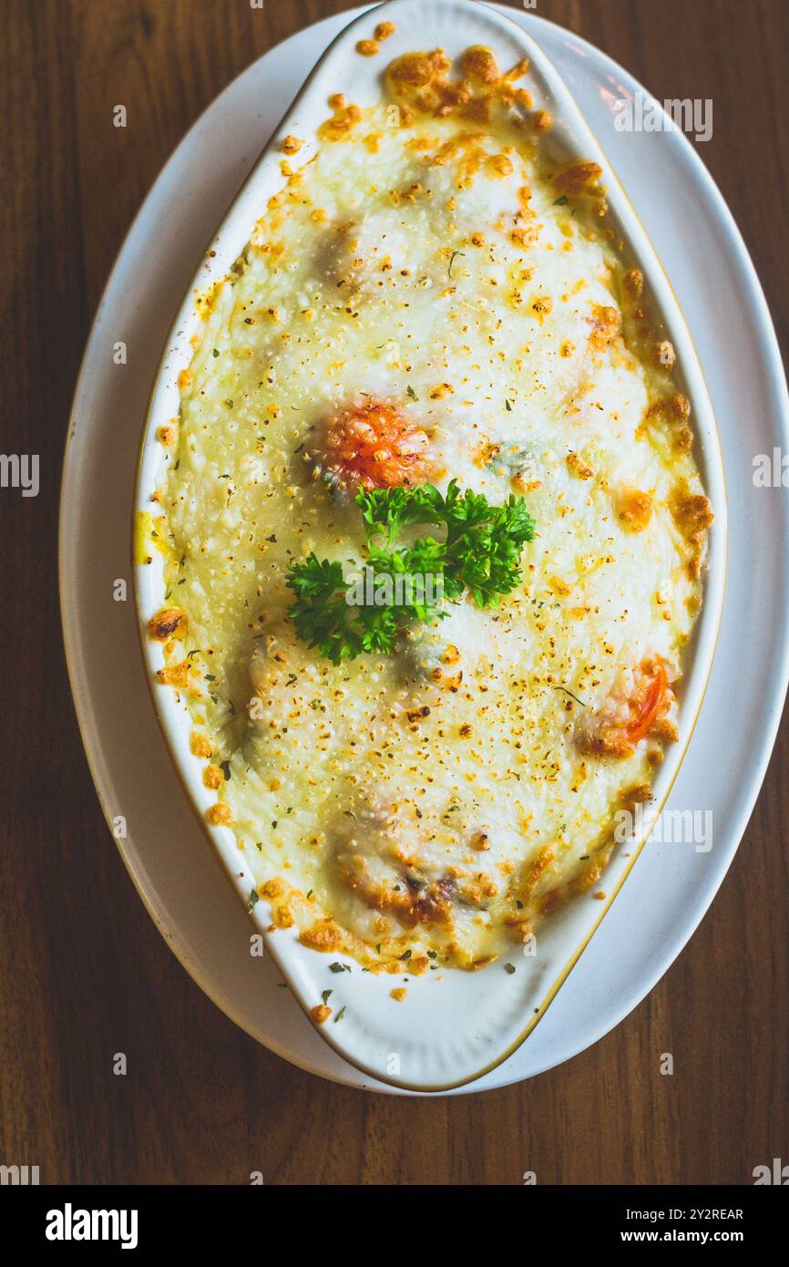 Gulai Salmon Baked Rice Rice baked in creamy and flavourful gulai Padang sauce with salmon and topped with cheese Stock Photo