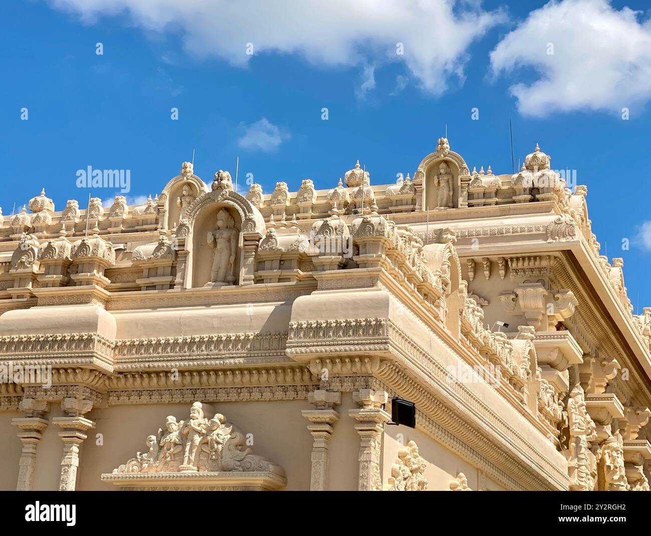 A detailed view of ornate carvings on the exterior of a Hindu temple ...