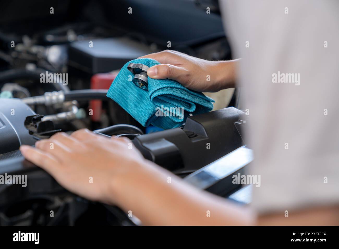 The young woman is checking the car's radiator Stock Photo - Alamy